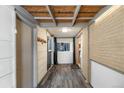 Home features a long hallway with wood-look floors and access to a screened porch at 8010 W Chestnut Dr, Littleton, CO 80128