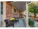 Inviting covered porch with brick detail and cozy seating perfect for relaxing outdoors at 6839 E Briarwood Dr, Centennial, CO 80112