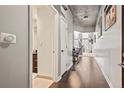 Long hallway with hardwood floors leading to the living area and adjacent bathroom at 891 14Th St # 2712, Denver, CO 80202
