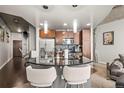 Kitchen with stainless steel appliances, breakfast bar, and modern hanging lights at 891 14Th St # 2712, Denver, CO 80202