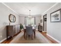 Elegant dining room featuring hardwood floors, a chandelier, and ample natural light at 16662 W 61St Pl, Arvada, CO 80403