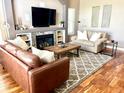 Inviting living room features a stone fireplace, TV, and stylish furniture at 16662 W 61St Pl, Arvada, CO 80403