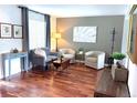Comfortable sitting area with modern chairs, wood floors, and natural lighting at 16662 W 61St Pl, Arvada, CO 80403