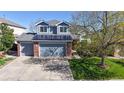Inviting two-story home with solar panels, brick accents, two-car garage, and well-maintained landscaping at 9567 W 107Th Dr, Broomfield, CO 80021
