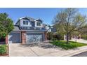Beautiful two-story home with gray siding, solar panels, brick accents and an attached two-car garage at 9567 W 107Th Dr, Broomfield, CO 80021