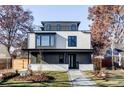 Modern two-story home with a flat roof, large windows, a covered porch, and manicured landscaping at 2471 Quitman St, Denver, CO 80212