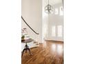 Grand two-story foyer featuring hardwood floors, patterned glass doors, and a statement light fixture at 2540 S Monroe St, Denver, CO 80210