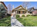 Beautiful home with a manicured lawn, complemented by a sidewalk leading to the welcoming front entrance at 1111 S Corona St, Denver, CO 80210
