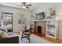 Inviting living room with a brick fireplace, hardwood floors, and a view of the front porch at 1111 S Corona St, Denver, CO 80210