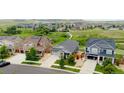 Wide shot of home showing location within community with green space and nearby houses at 11817 Phoebe St, Parker, CO 80134