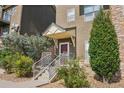 Inviting townhome entrance featuring a covered porch, stone accents, and manicured landscaping for added curb appeal at 18846 E Yale Cir # A, Aurora, CO 80013