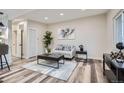 Cozy living room with neutral tones, modern decor, stylish furnishings, and wood-like flooring at 3656 Fairfax St, Denver, CO 80207