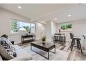 Bright living room with large windows, modern furnishings, and neutral colors offers an open space at 3656 Fairfax St, Denver, CO 80207