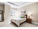 Calm bedroom featuring neutral colors, a large window, and two decorative lamps on wood nightstands at 7600 Landmark Way # 904, Greenwood Village, CO 80111