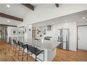 Bright, spacious kitchen with white cabinets, stainless steel appliances, and an island with bar seating at 2300 Willow Ln, Lakewood, CO 80215