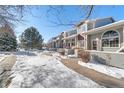 Townhome community with snow-covered sidewalks and landscaping at 1805 W 101St Ave, Thornton, CO 80260