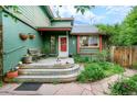 Charming front porch with welcoming bench, serene Buddha statue, and lush garden at 3982 Arbol Ct, Boulder, CO 80301