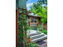 Inviting front porch with wooden deck, bench, and peaceful Buddha statue at 3982 Arbol Ct, Boulder, CO 80301