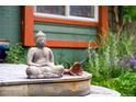 Close-up of a Buddha statue on the wooden deck of the front porch at 3982 Arbol Ct, Boulder, CO 80301