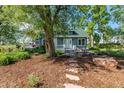 Quaint home featuring a lush front yard with mature trees and a cozy porch at 13183 N 95Th St, Longmont, CO 80504