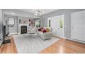 Bright living room with a modern fireplace, hardwood floors, and stylish decor at 13183 N 95Th St, Longmont, CO 80504