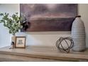 Close-up of vases, picture frames and abstract shapes on top of a wooden dresser at 1705 Stonehenge Dr, Lafayette, CO 80026