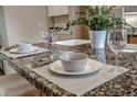 Close-up of kitchen island featuring granite countertops, tableware, and plant at 1705 Stonehenge Dr, Lafayette, CO 80026
