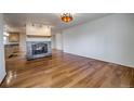A spacious living room with hardwood floors and a stone fireplace at 1705 Stonehenge Dr, Lafayette, CO 80026