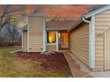 A close-up of the house entrance with a well-kept lawn, landscaping, and visible house number at 11623 W Hornsilver Mtn, Littleton, CO 80127