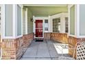 Covered front entrance with red door and brick columns at 1894 S Marshall Cir, Lakewood, CO 80232