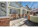 Front porch with rocking chairs and brick columns at 1894 S Marshall Cir, Lakewood, CO 80232