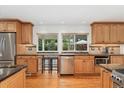 Bright kitchen with stainless steel appliances, granite countertops, and a view to the backyard at 3765 E Easter Dr, Centennial, CO 80122