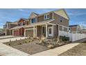 Charming two-story home featuring neutral siding, a well-manicured lawn, and a welcoming covered porch at 5541 Killarney Ct, Denver, CO 80249