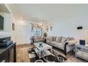 Inviting living room with cozy seating, a stylish rug, and lots of natural light at 5541 Killarney Ct, Denver, CO 80249