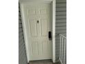 A welcoming view of the front door entrance with a secure lock keypad and traditional door knocker at 942 S Walden St # 206, Aurora, CO 80017