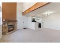 Open living room features a stone fireplace and a view into the adjacent kitchen at 942 S Walden St # 206, Aurora, CO 80017