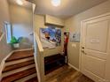 Inviting entryway with stairs, storage bench, and artwork at 9494 Halstead Ln, Lone Tree, CO 80124