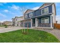 Charming two-story home featuring a three-car garage, stone accents and a well-manicured lawn at 13477 Valentia St, Thornton, CO 80602