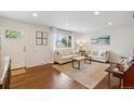 Bright living room featuring hardwood floors, neutral decor, and ample natural light through large windows at 806 S Jersey St, Denver, CO 80224