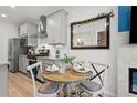 Charming dining area with a round table and kitchen view at 8051 Yampa River Ave, Littleton, CO 80125