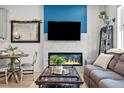 Inviting living room featuring a fireplace, comfortable seating, and stylish decor at 8051 Yampa River Ave, Littleton, CO 80125