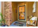 Welcoming front porch featuring a decorative screen door, potted plants, and seating at 8845 W 81St Dr, Arvada, CO 80005
