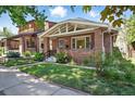 Charming brick home featuring a well-manicured lawn and inviting front porch area at 3437 W 35Th Ave, Denver, CO 80211