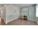 Bright and airy room showcasing pale-green walls, hardwood floors, bright windows and a vintage table at 1800 Vantage Pkwy, Berthoud, CO 80513
