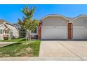 Home with a well-maintained lawn, a two-car garage, and a patriotic display at 3104 Newport Cir, Castle Rock, CO 80104