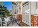 Inviting front porch featuring a cozy chair, decorative pillow, and a 'Home Sweet Home' welcome mat at 3104 Newport Cir, Castle Rock, CO 80104