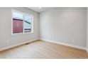 Bright bedroom featuring a large window and light wood floors at 1825 Morgan Dr, Erie, CO 80516