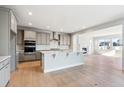 Modern eat-in kitchen featuring gray cabinets, stainless steel appliances, and a center island at 1825 Morgan Dr, Erie, CO 80516