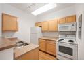 Bright kitchen featuring modern appliances, light wood cabinets, and durable countertops at 444 17Th St # 802, Denver, CO 80202