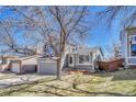 Charming two-story home featuring a well-maintained front yard, attached garage, and inviting entrance at 9851 Castle Ridge Cir, Highlands Ranch, CO 80129